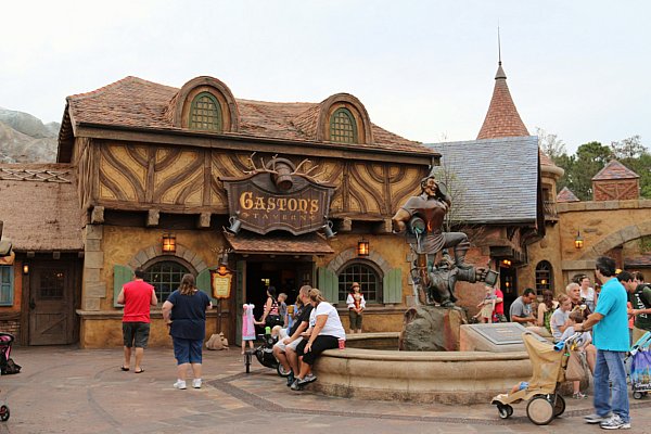 a building that says Gaston\'s Tavern on it with a fountain in front