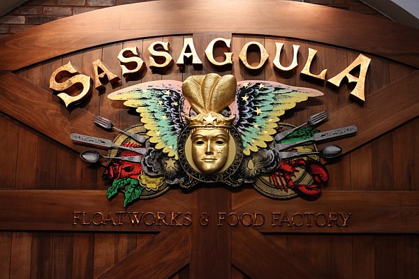 a colorful wooden sign that says Sassagoula Floatworks & Food Factory