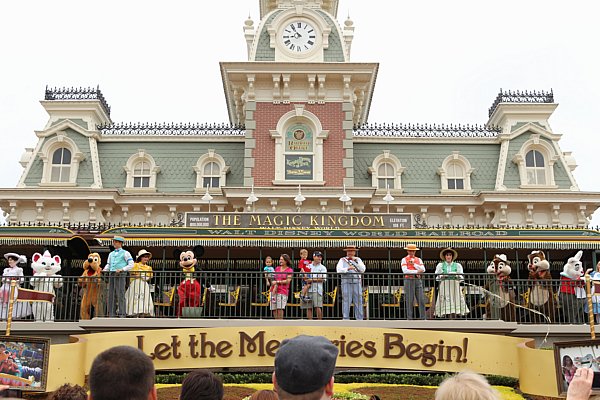 people standing in front of the Main Street train station at Disney\'s Magic Kingdom