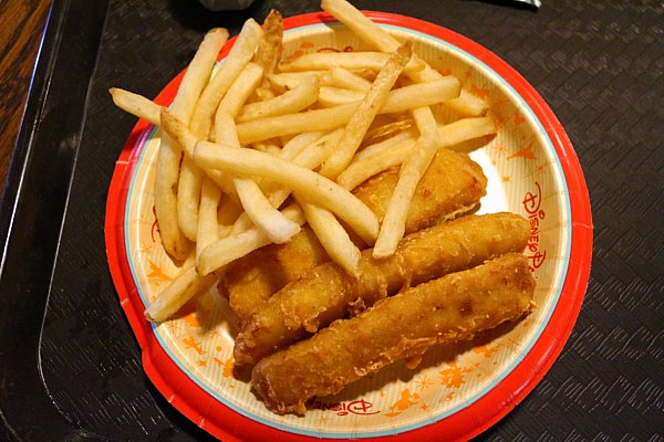 fried fish strips and french fries on a yellow and red paper plate