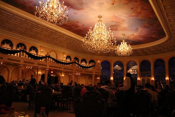 a large ballroom themed dining room with elaborate chandeliers hanging from the ceiling