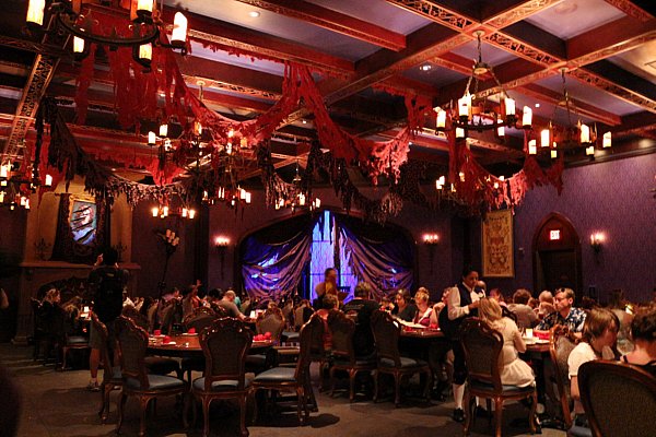 a dining room with tattered fabric hanging from the ceiling