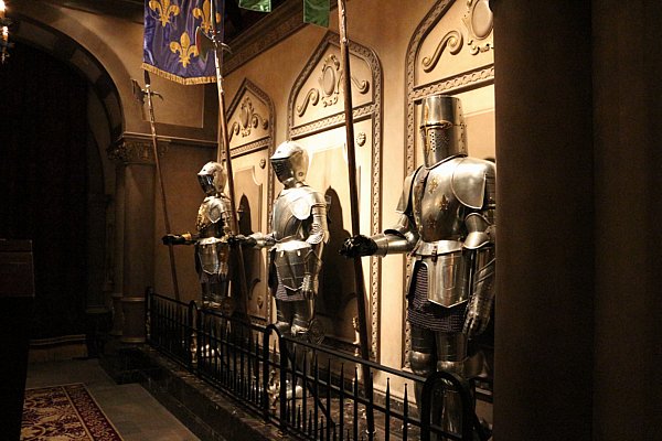 a row of suits of armor against a wall