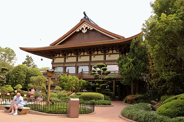 A large Japanese style building with gardens in front