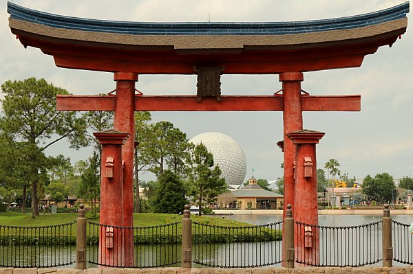a view of Epcot\'s Spaceship Earth through a Japanese style arch