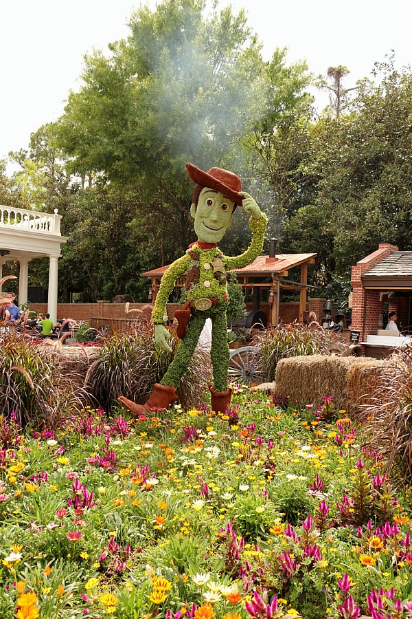 a topiary of Woody from Toy Story in a garden