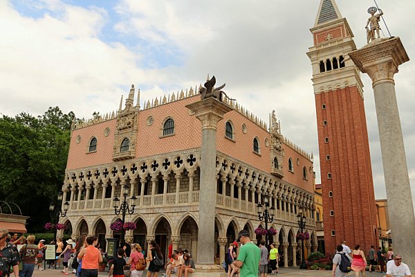 A group of people walking in front of a building in the Italy Pavilion in Epcot