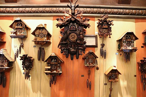 a bunch of cuckoo clocks hanging on a wall