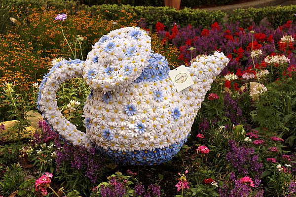 A close up of a flower garden resembling a teapot