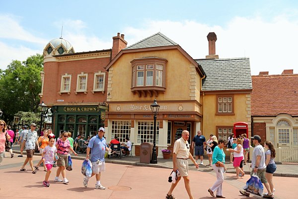 A group of people walking through the United Kingdom Pavilion in Epcot