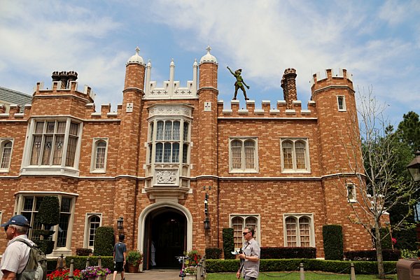 A large stone building with a Peter Pan topiary on the roof