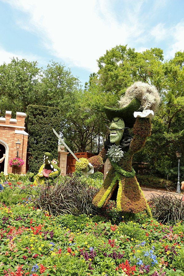 a Captain Hook and crocodile topiary in a garden