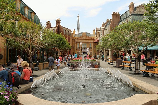 A fountain surrounded by French style buildings