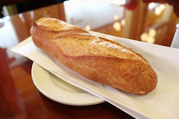 a small crusty baguette on a white plate