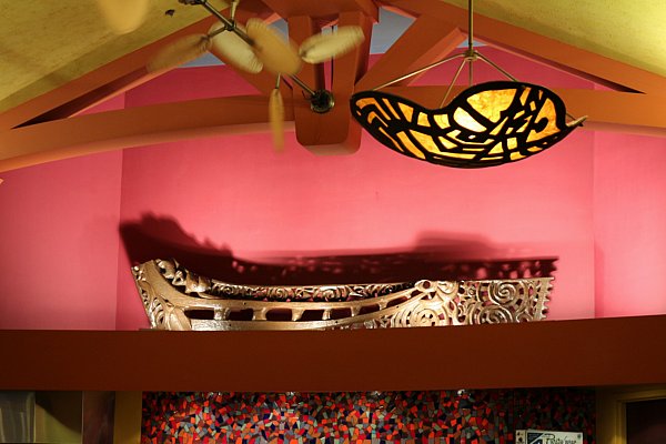 A wall display in a restaurant with a colorful light hanging nearby