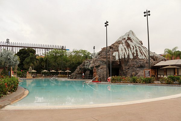 a large empty swimming pool with a volcano shaped structure to the side