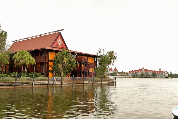 A colorful Polynesian style building surrounded by water