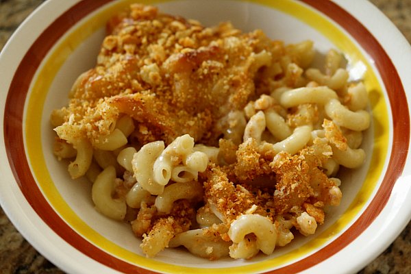 baked macaroni and cheese in a brown, yellow, and white bowl