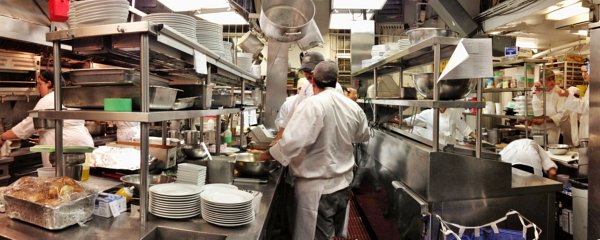 People preparing food in a commercial kitchen