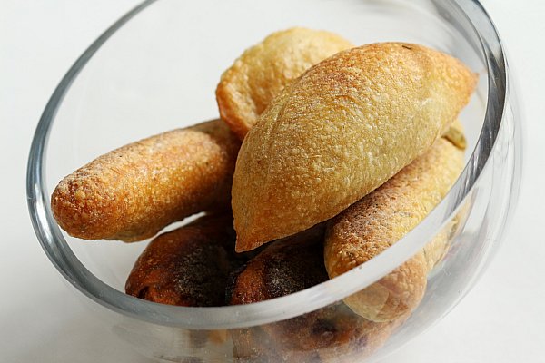 a closeup of small loaves of bread in a glass bowl
