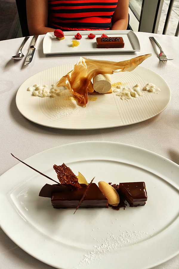 two artfully plated desserts on white plates