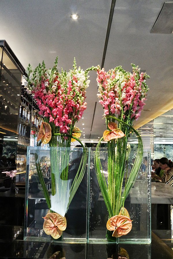 two vases of flowers on a table