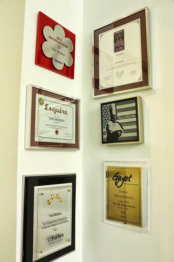 framed awards arranged on a wall