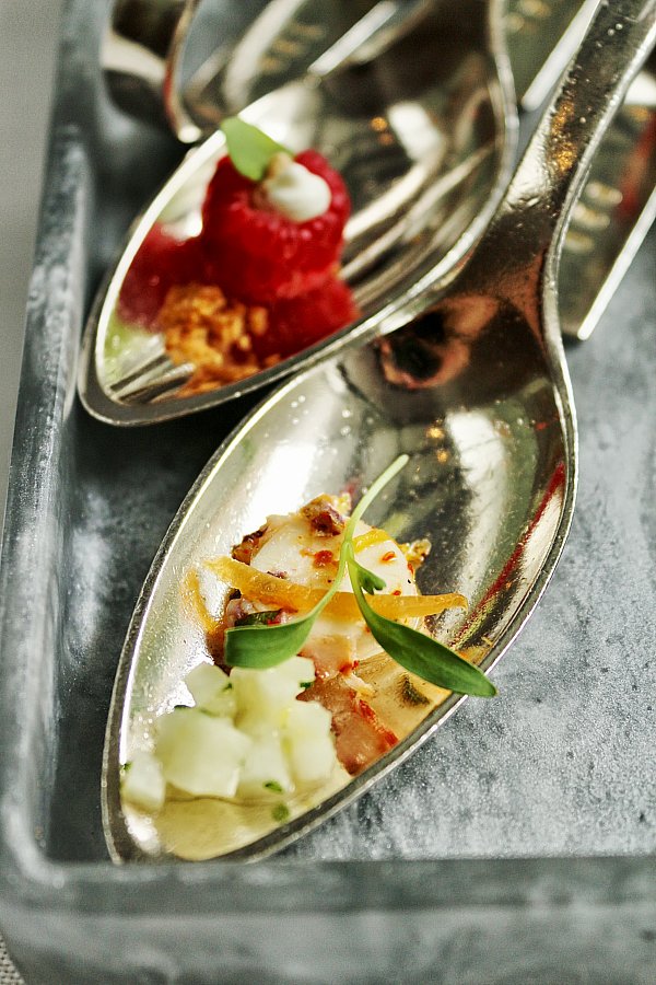 a metal spoon topped with a small bite of food