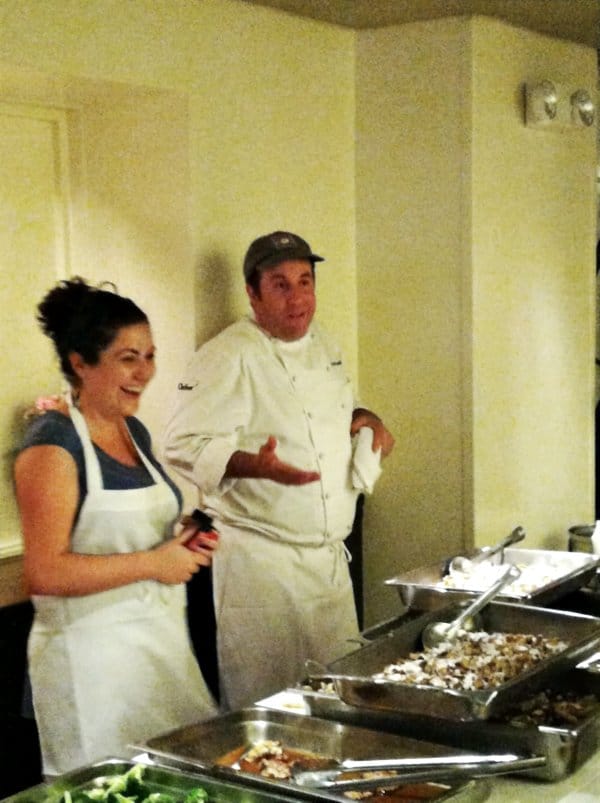 A man and a woman standing in front of a buffet table