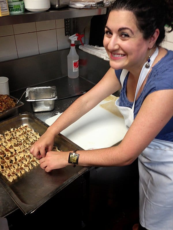 A woman preparing food in a kitchen