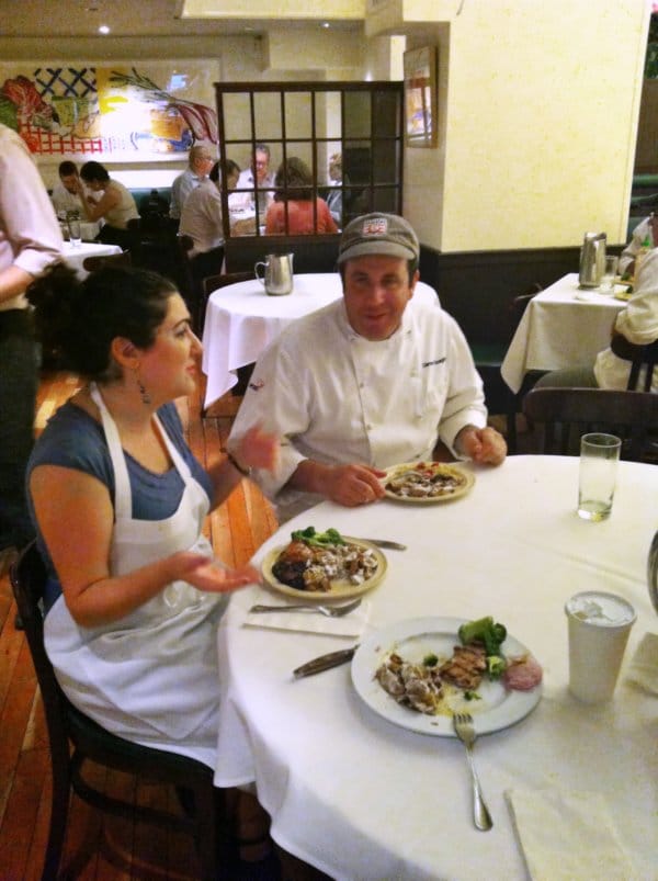 A group of people sitting at a table eating food