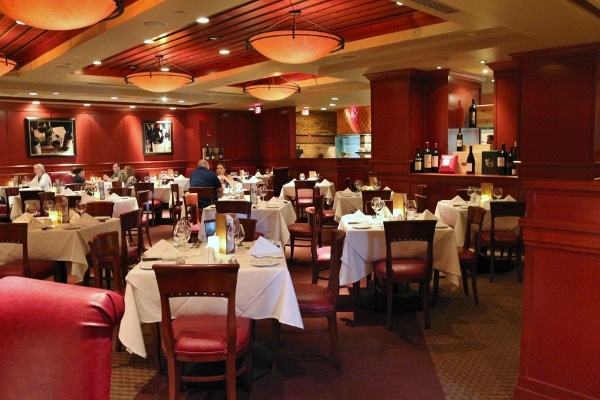 wide view of a restaurant interior with tables, chairs, and warm lighting