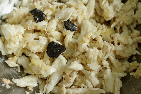 closeup of a mixture of crab meat with sliced black truffles