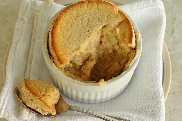 overhead view of a half eaten souffle in a white ramekin