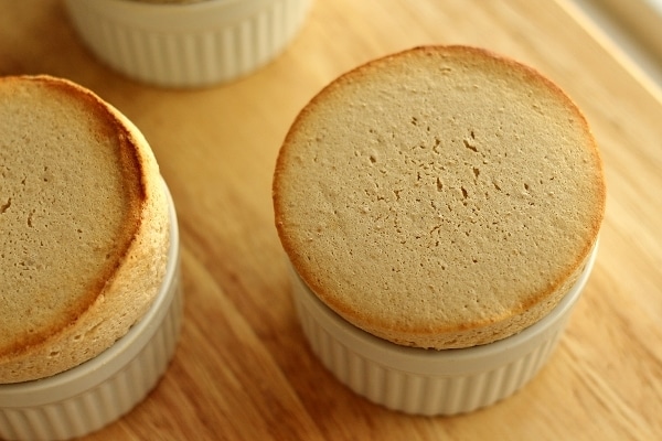 overhead view of souffles in white ramekins on a wooden board