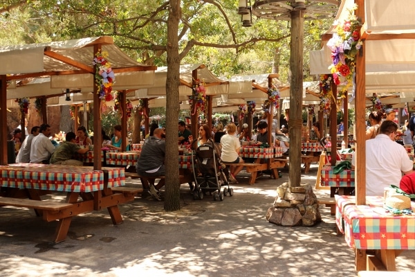 rows of picnic tables with canopies over the tops to block out some sun