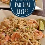 shrimp pad thai noodles topped with chopped peanuts on two square plates