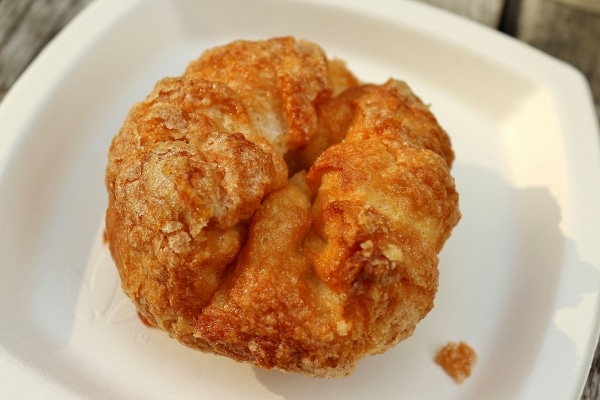 overhead view of a round flaky pastry on a white plate