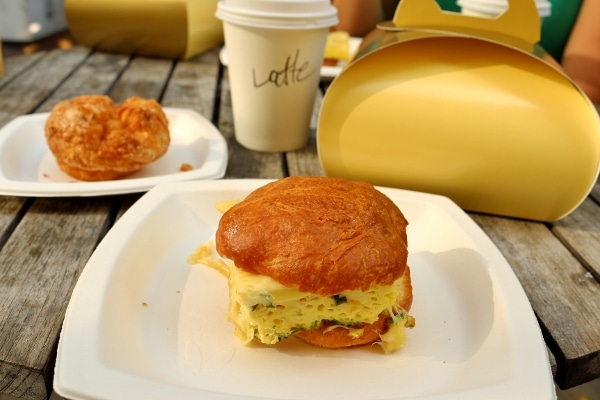 an egg sandwich on a white plate on a table