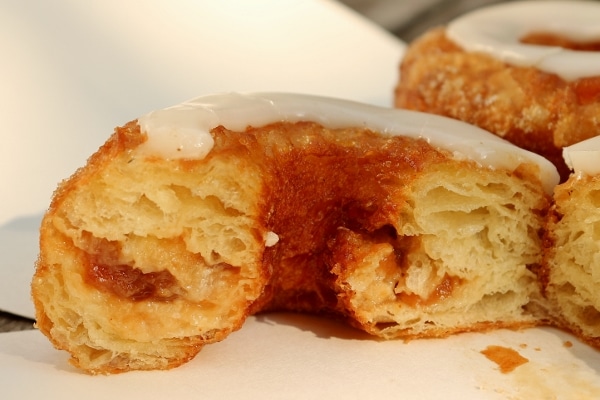 closeup of a cross section of a Cronut with flaky layers and apple filling