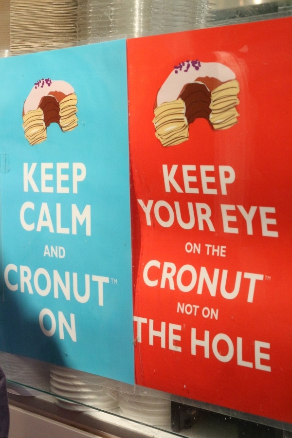 blue and red signs with images of Cronuts and text on them