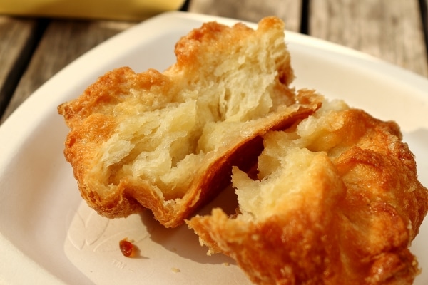 a cross section of a flaky pastry broken in half to show the layers