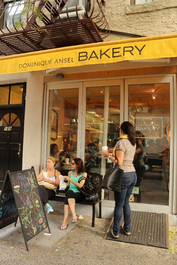 A group of people standing in front of the Dominique Ansel Bakery