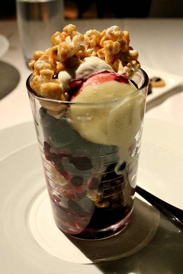 a small glass parfait filled with ice cream and caramel popcorn