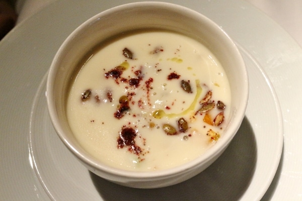 overhead view of a bowl of white creamy soup