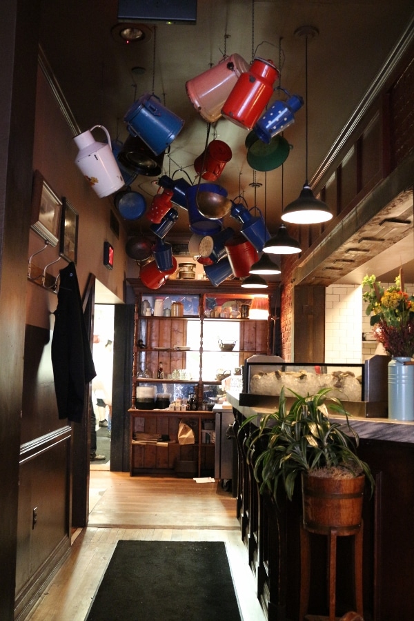 colorful jugs hanging from a wood paneled ceiling