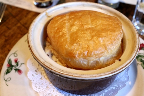 A closeup of a pot pie topped with a puff pastry round