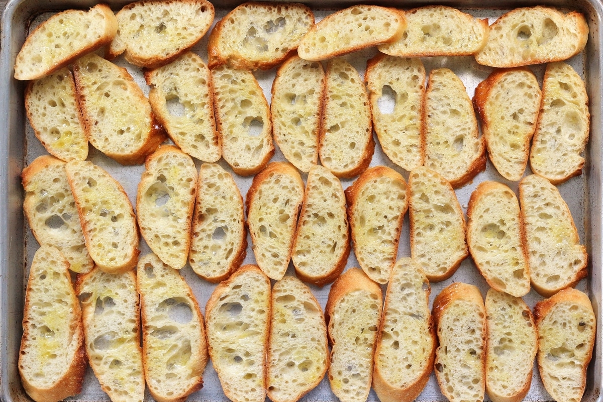 baguette slices arranged on a baking sheet