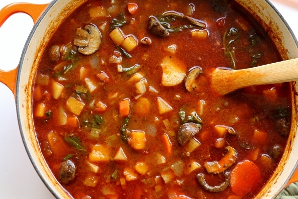 overhead view of a large pot of soup with various vegetables