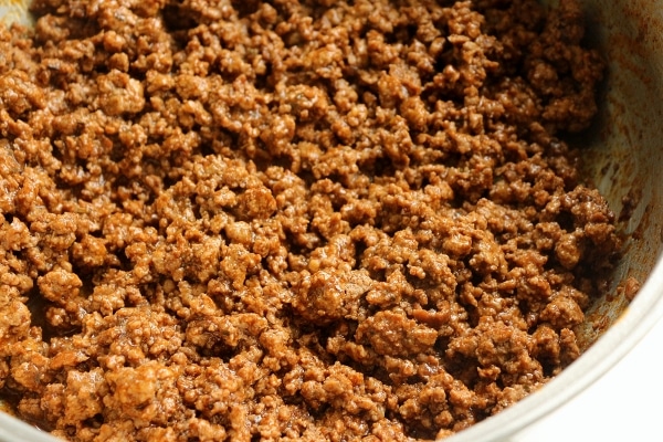 cooked ground beef in a metal skillet